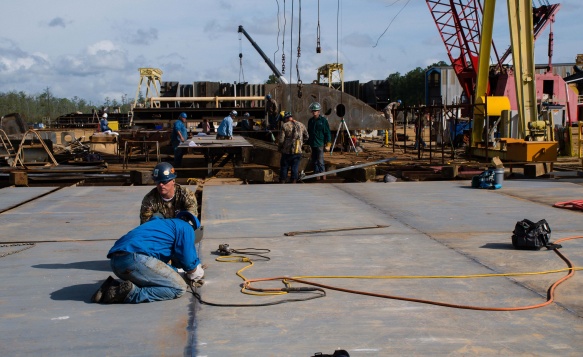 Action photo of Engineers securing some key parts together