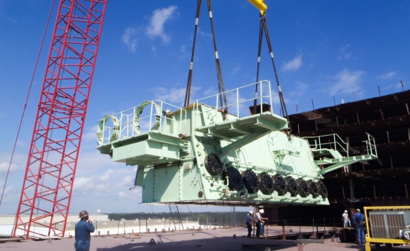 A Crane lowers some key parts during construction of the Pasha Hawaii 's MV Marjorie C vessel